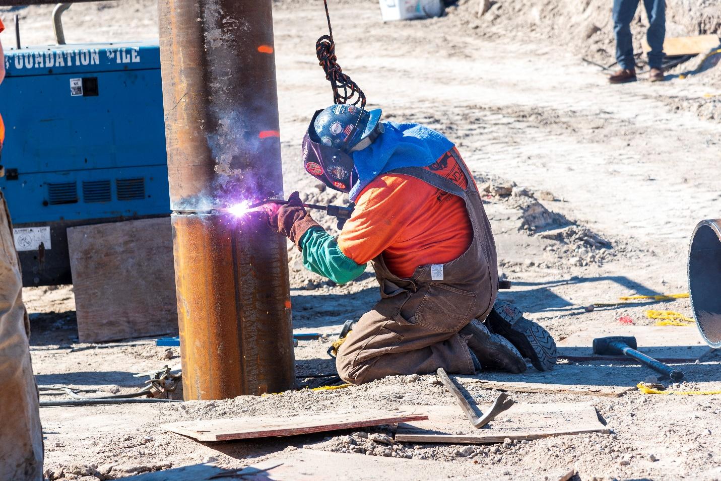 A welder works at the SR 11 construction site.